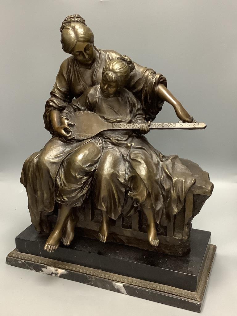 A 20th century cold cast bronze resin figure group of a mother and daughter playing an instrument, height 50cm